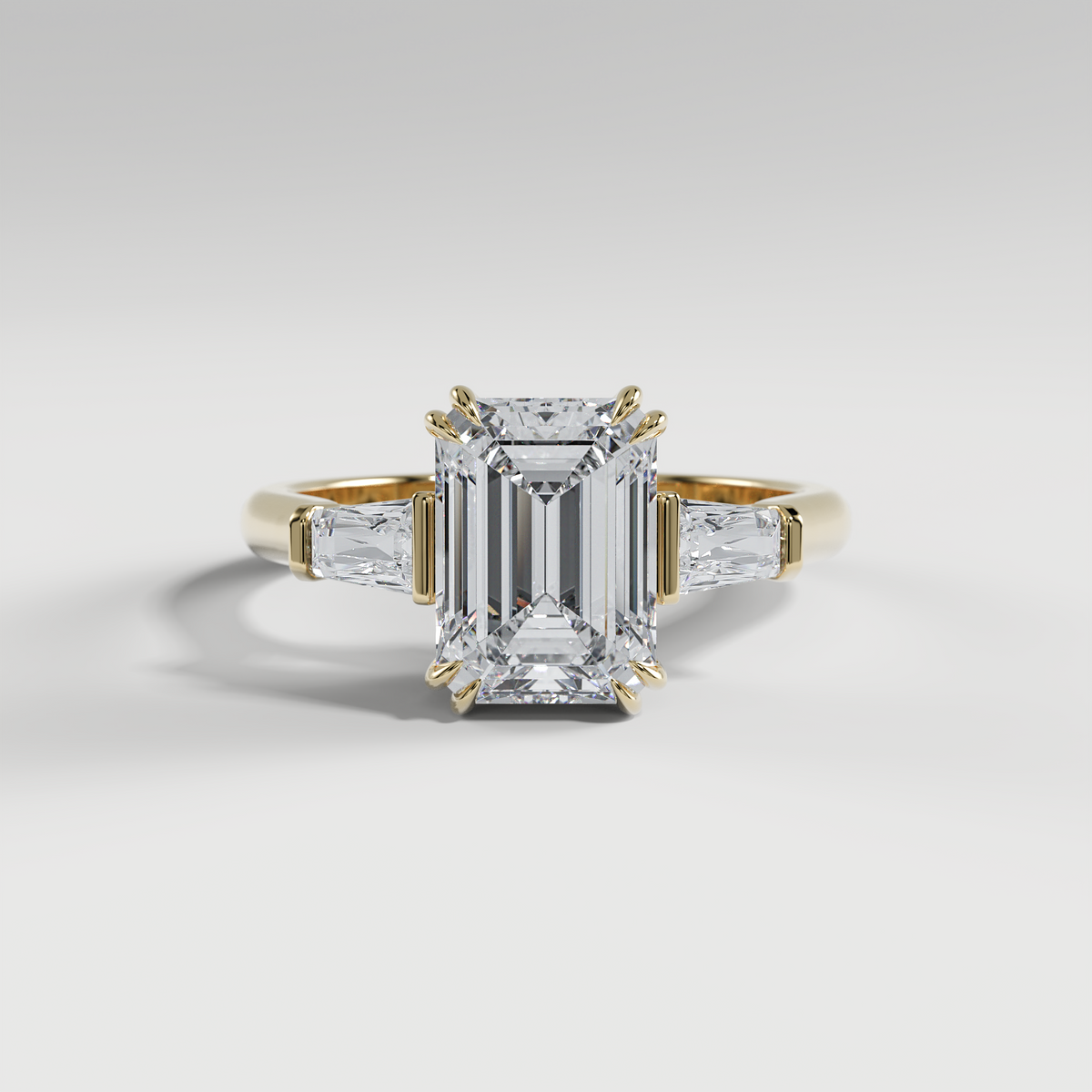 LILY - Emerald Three-Stone Engagement Ring with Tapered Baguette Side Stones and Polished Cathedral Band