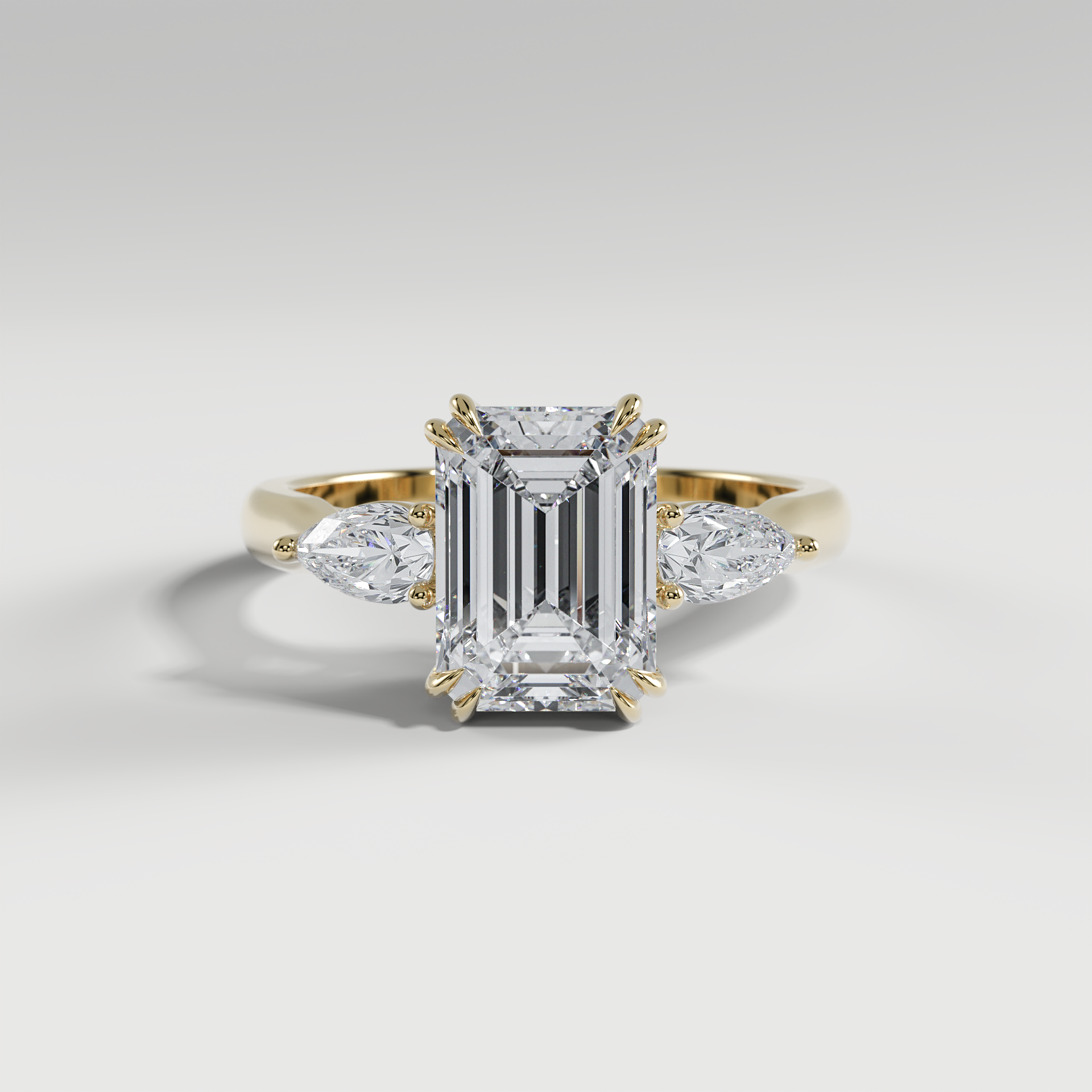 HAZEL - Emerald Three-Stone Engagement Ring with Pear Side Stones and Polished Cathedral Band