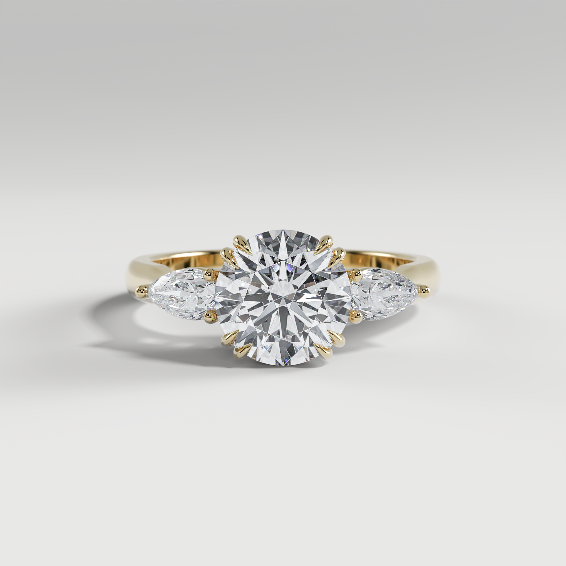 HAZEL - Round Three-Stone Engagement Ring with Pear Side Stones and Polished Cathedral Band